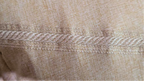 Beige long-sleeve shirt on a mannequin with close-up of fabric texture on a beige background
