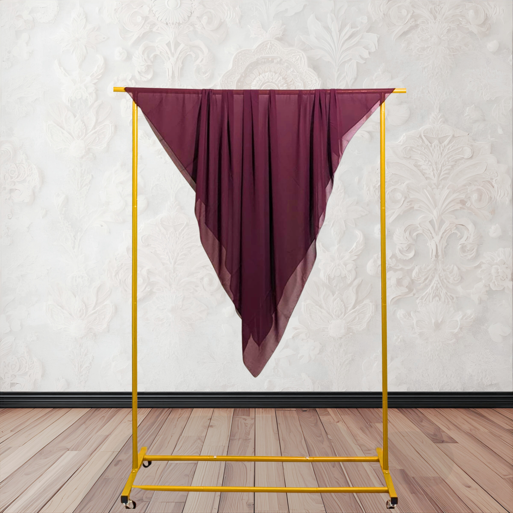 coffee color fabric draped over a yellow garment rack against a white wall.