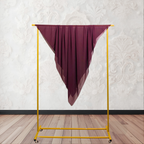 coffee color fabric draped over a yellow garment rack against a white wall.