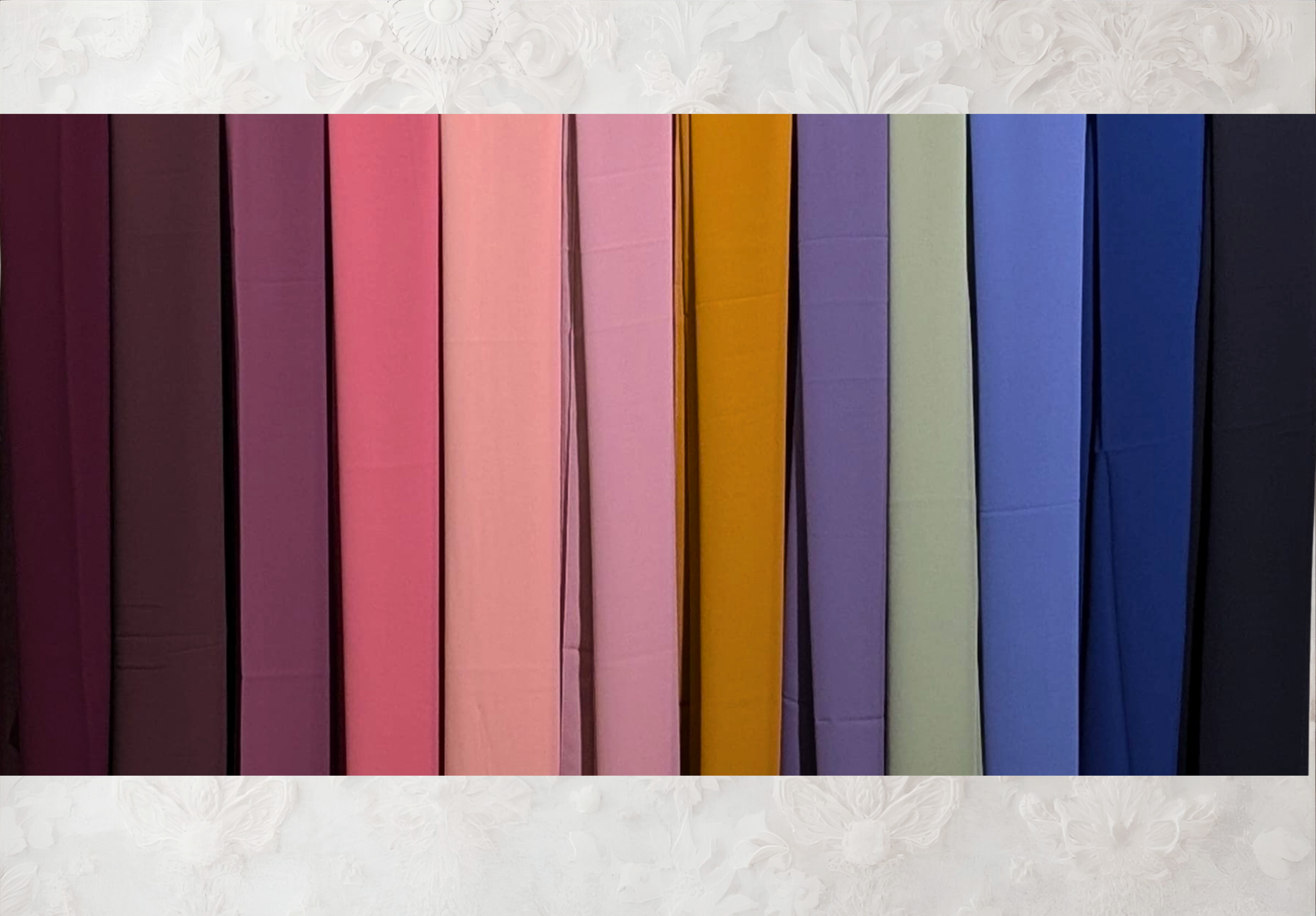 Color swatch chart on a textured wall with wooden floor