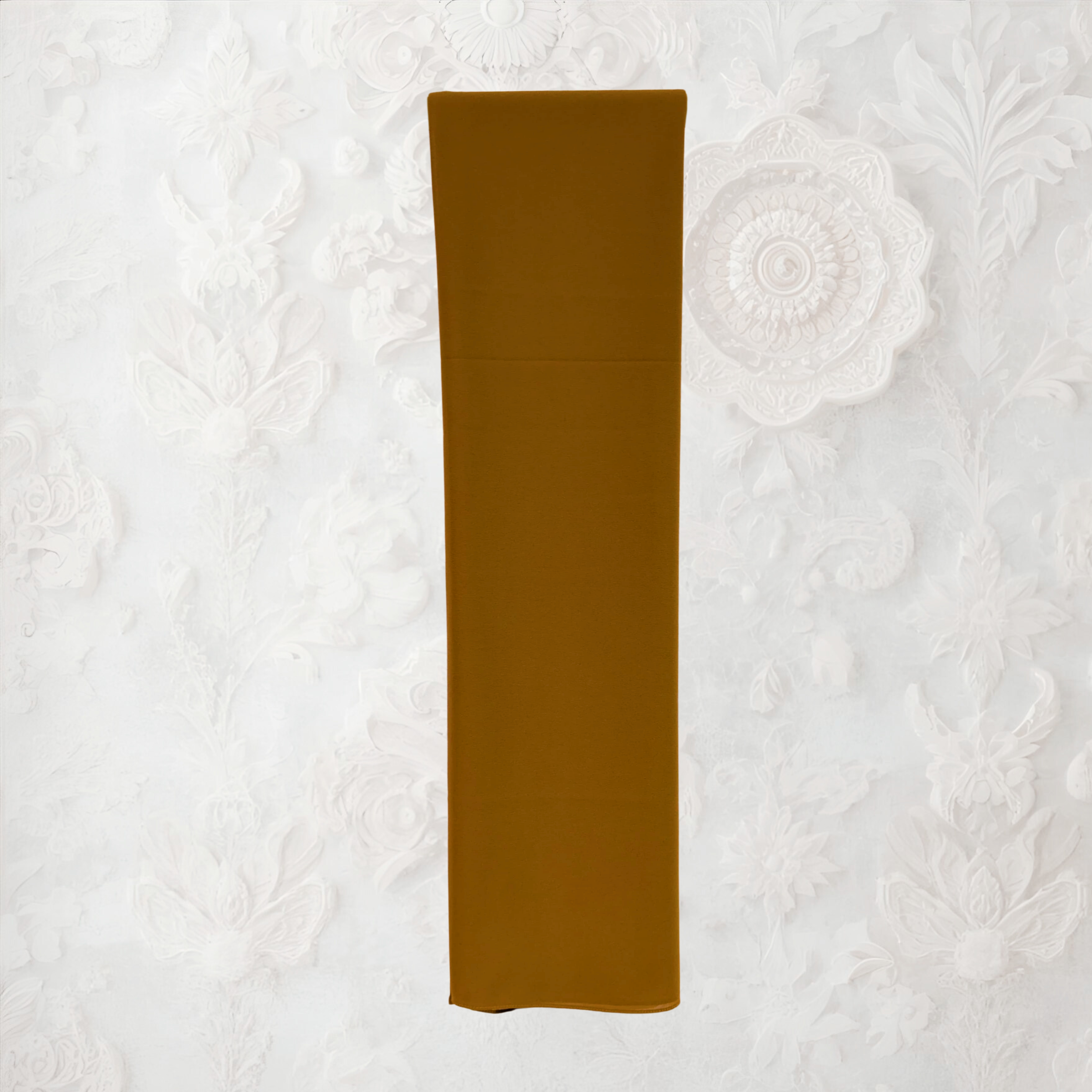 Folded pink fabric on a textured white background chiffon hijab