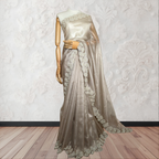 Saree with lace detailing on a mannequin against a white wall.