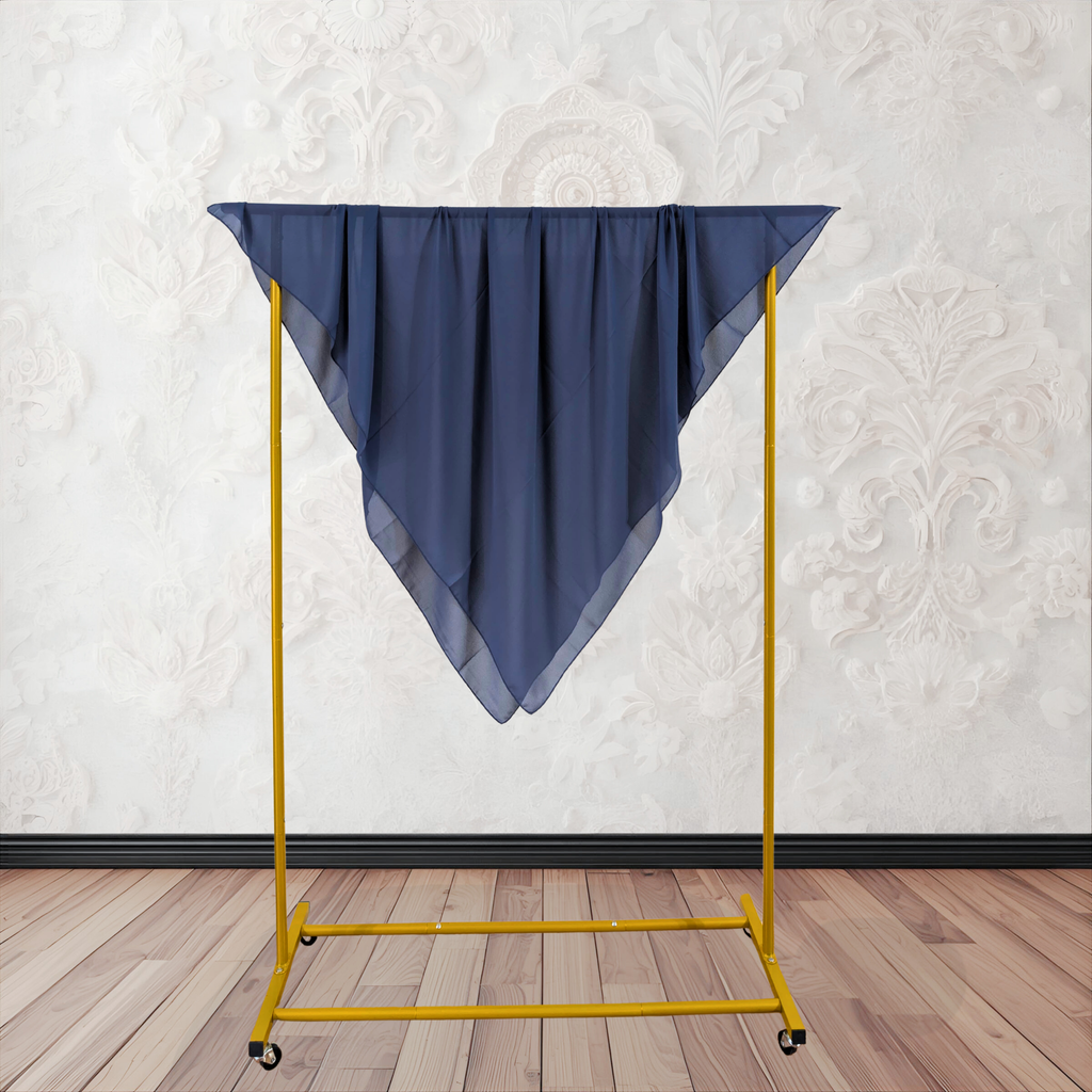 Blue fabric draped over a yellow metal garment rack against a white wall.