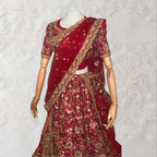 This exquisite red lehenga choli crafted from luxurious raw silk showcases intricate resham, zardosi, beads, sequins, and cut dana floral embroidery. The heavily embellished hemline and delicate cream butti accents enhance its sophisticated charm. Complete with a matching embroidered net dupatta featuring floral buttis and an elegant border, and a stitched blouse piece adorned with coordinating floral motifs, for wedding and bridal, pakistani, bangladeshi, indian, sri lankan.
