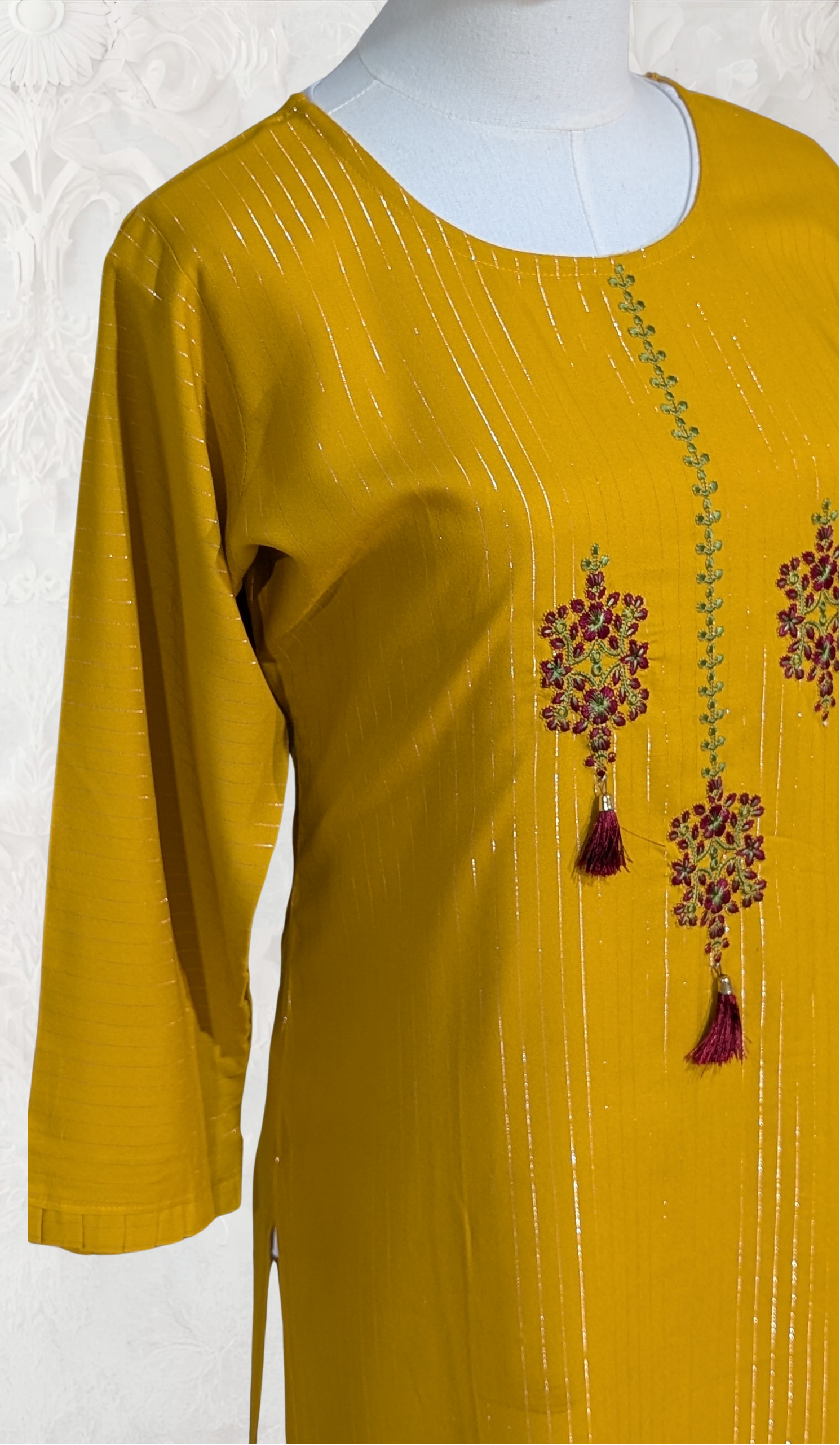 Yellow kurta with floral embroidery on a white background