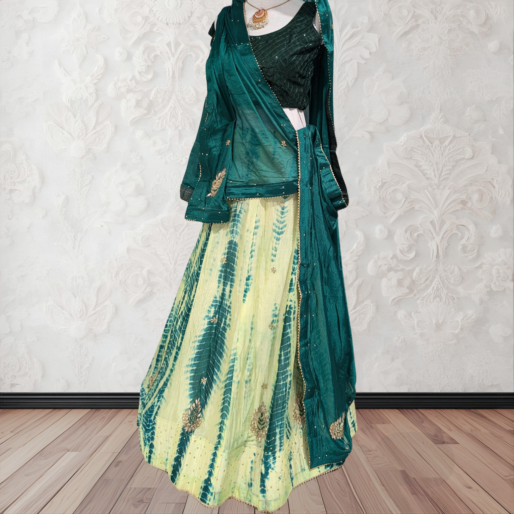 Green and yellow dress with matching jacket on a mannequin against a white wall.