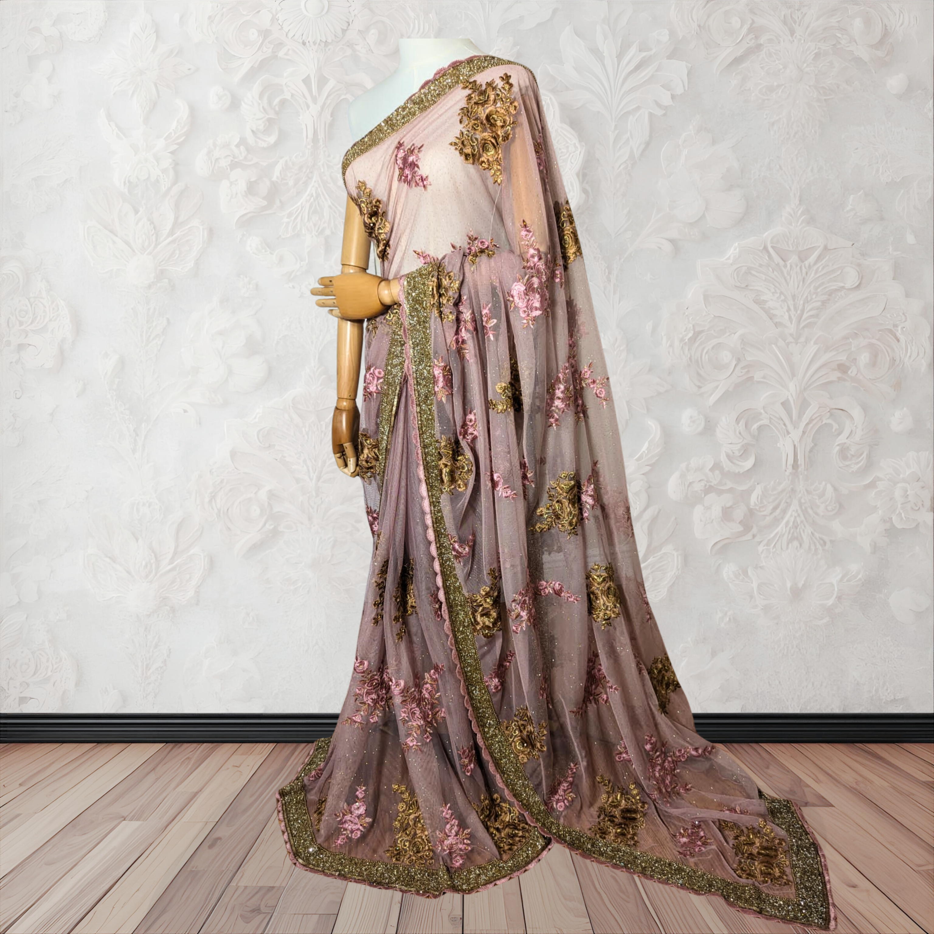 Decorative saree with floral and leaf patterns on a white background