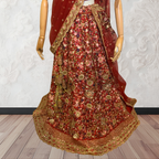 This exquisite red lehenga choli crafted from luxurious raw silk showcases intricate resham, zardosi, beads, sequins, and cut dana floral embroidery. The heavily embellished hemline and delicate cream butti accents enhance its sophisticated charm. Complete with a matching embroidered net dupatta featuring floral buttis and an elegant border, and a stitched blouse piece adorned with coordinating floral motifs, for wedding and bridal, pakistani, bangladeshi, indian, sri lankan.
