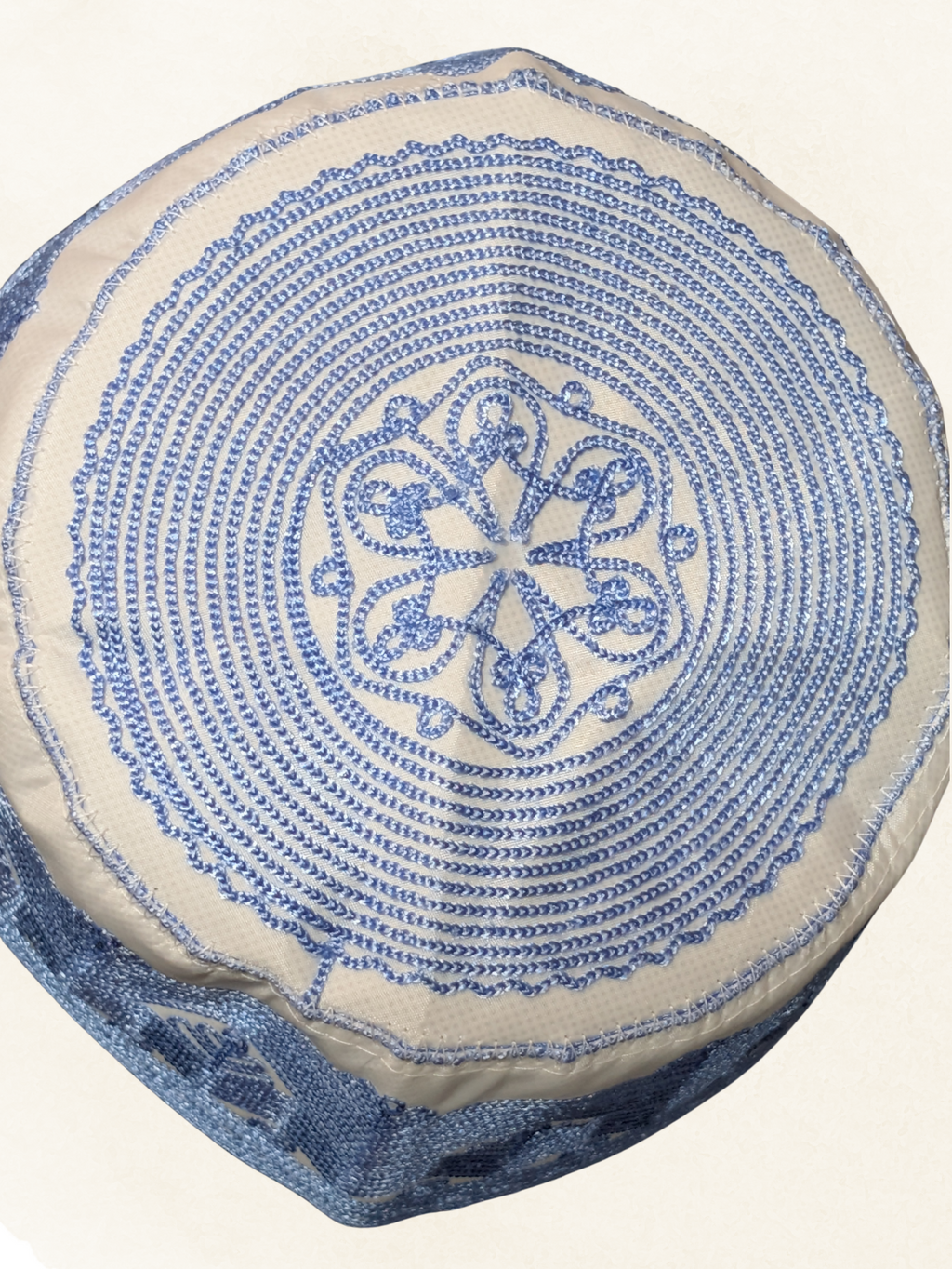 Decorative pillow with blue circular pattern on a beige background