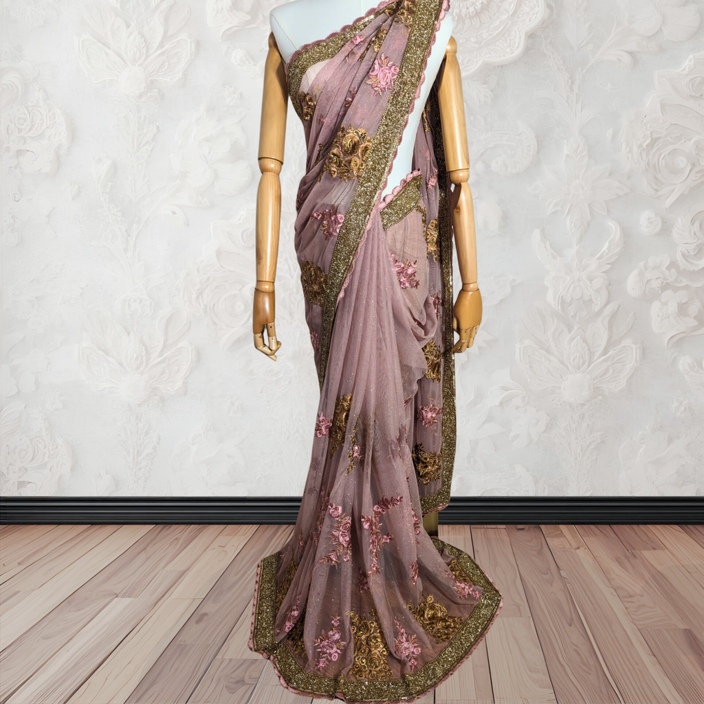 Saree with floral embroidery on a mannequin against a white wall.