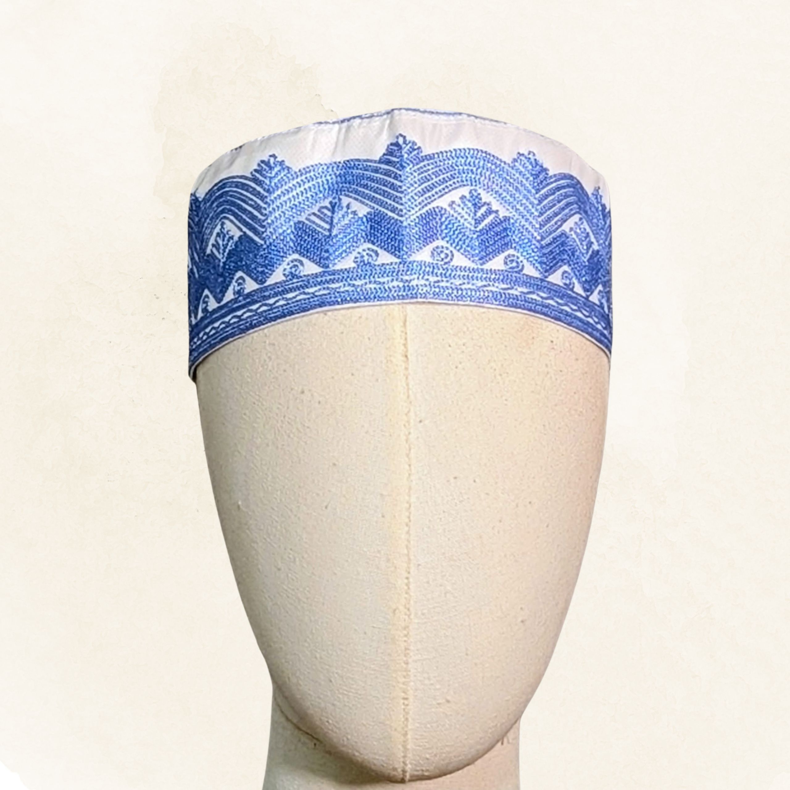 Topi Kufi white with blue embroidery.