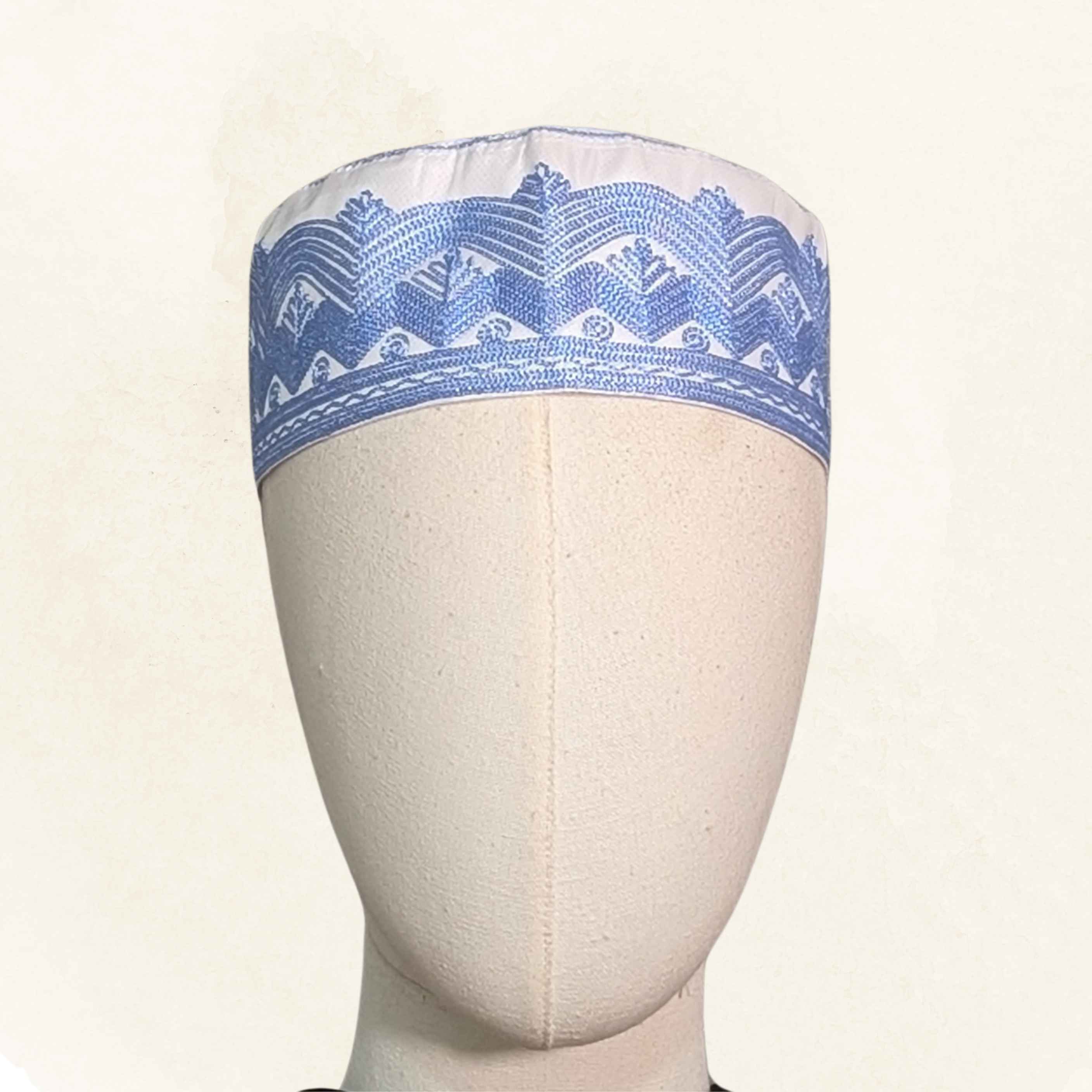 Topi Kufi white with blue embroidery.