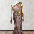 Saree with floral embroidery on a mannequin against a white wall.