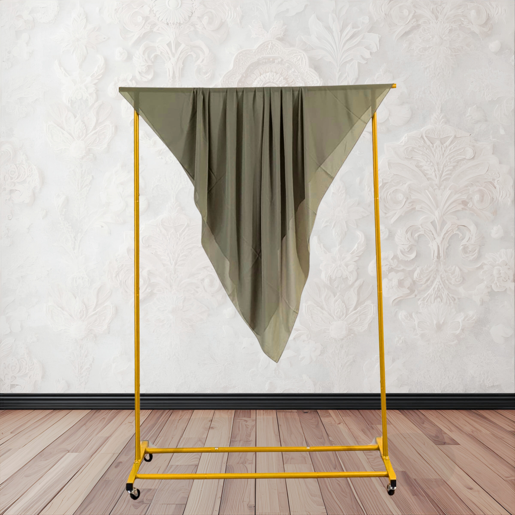 Yellow clothing rack with a green garment against a white wall.
