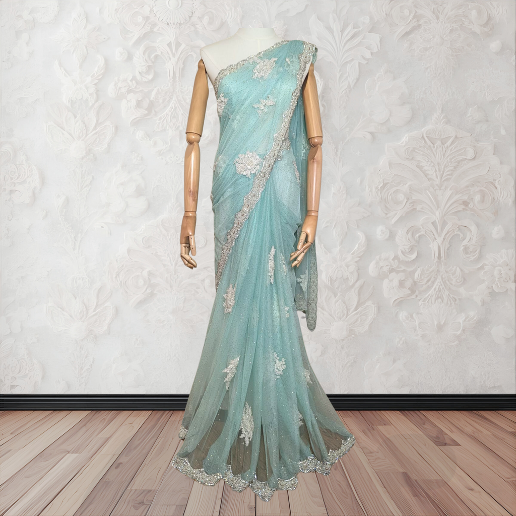 Mannequin wearing a light blue saree with white floral patterns on a white background