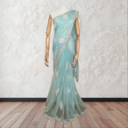 Mannequin wearing a light blue saree with white floral patterns on a white background