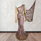 Saree with floral patterns on a mannequin against a white wall.